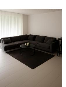 a living room with a couch and a table at Mountain view in Martigny-Ville