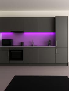 a kitchen with purple lighting in a room at Mountain view in Martigny-Ville