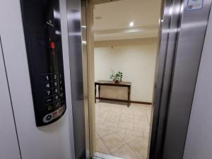 an elevator door leading to a room with a table at Dpto vista hermosa in Osorno