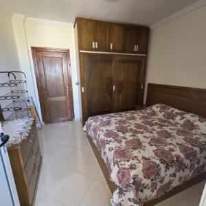 a bedroom with a bed and a dresser at Lmadghri6 in Ras El Ma +1 photo