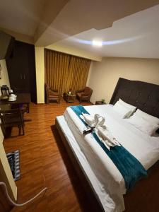 a bedroom with a large bed with a robe on it at Refugio del Valle del Sol in Urubamba