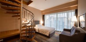 a hotel room with a bed and a spiral staircase at Beijing XinQiao Hotel in Beijing +121 photos