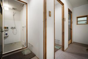 a bathroom with a shower and a mirror at The Deer Park Inn in Nara +35 photos