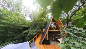 a tree house in the middle of a forest at Fészek Lombház in Kismaros