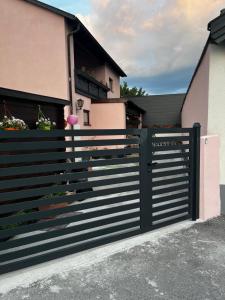 a black fence in front of a house at Tom & Jerry - Family Apartment in Pottendorf