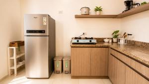 a kitchen with a stainless steel refrigerator and a stove at Hooga Home in Cebu City