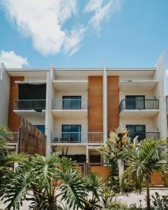 a building with palm trees in front of it at Hooga Home in Cebu City