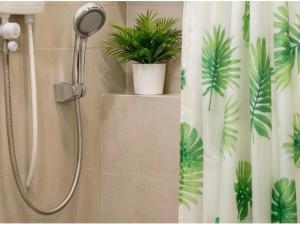 a shower with a shower head in a bathroom at Hooga Home in Cebu City +54 photos