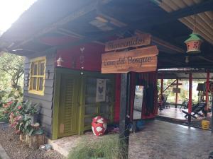 a small house with a sign in front of it at Casa del Bosque in Mocoa