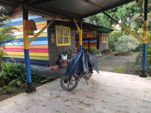 a motorcycle parked in front of a colorful house at Casa del Bosque in Mocoa