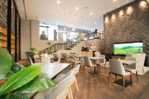 a restaurant with tables and chairs and a staircase at Changi Transit Hotel Terminal 1 in Singapore +17 photos