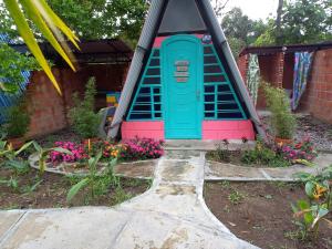 a play house in a garden with flowers at Casa del Bosque in Mocoa +3 photos