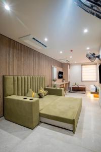 a bedroom with a large bed and a couch at Hotel IKOY A Luxury Boutique Near Ashok Vihar & Model Town in New Delhi