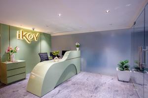 a lobby with a desk with a sign on the wall at Hotel IKOY A Luxury Boutique Near Ashok Vihar & Model Town in New Delhi