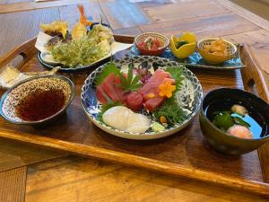 a tray with several bowls of food on a table at 阿部倉温泉 Abekura Onsen in Yokosuka