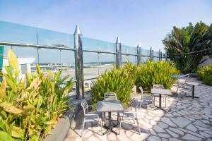 a row of tables and chairs on a patio at Changi Transit Hotel Terminal 1 in Singapore