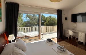 a bedroom with a bed and a large window with a balcony at Villa Aqua in Vrbanj
