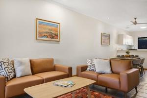 a living room with a couch and a table at Dunes Escape in Broome +11 photos
