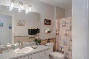 a bathroom with a sink and a toilet and a mirror at Roxy in Brunswick +16 photos