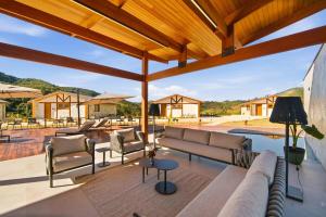 a patio with a couch and chairs and a pool at Casa ALPIN in São José dos Campos