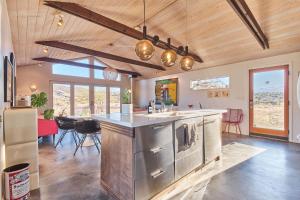 a kitchen with stainless steel appliances and a dining room at The Giddyup in Pioneertown