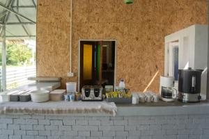 a counter with plates and other items on it at Butterfly Resort Hostel, Pai in Pai