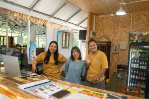 a group of people standing in front of a counter at Butterfly Resort Hostel, Pai in Pai