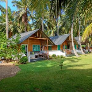 a house with a metal roof on a lawn at Salt Bay Kite and Dive Resort in Kalpitiya
