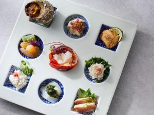 a white plate with different types of food on it at Toba Ocean Resort All-Inclusive Hotel in Toba