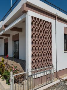 a facade of a building with a decorative wall at Little Paradise in Sotira