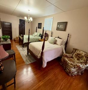 a bedroom with a bed and a chair at The Pecan House in Bainbridge