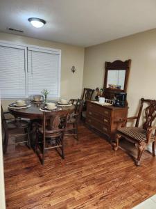 a dining room with a table and chairs and a mirror at The Pecan House in Bainbridge