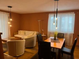 a living room with a couch and a table at Stelius Wien in Vienna