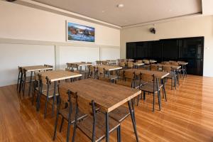 a classroom with tables and chairs and a projection screen at SANS Vibes Grand Surya Jember Mini Zoo in Panti