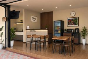 a waiting room with two tables and a counter at SANS Vibes Grand Surya Jember Mini Zoo in Panti