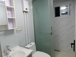 a bathroom with a toilet and a sink and a shower at KF Logement Wallis in Hihifo Airport