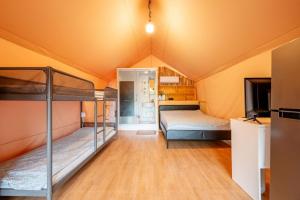 a room with two bunk beds in a tent at Seocheon Ocean Place Glamping Caravan in Seocheon
