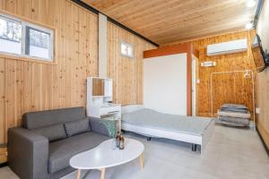 a living room with a couch and a table at Seocheon Ocean Place Glamping Caravan in Seocheon