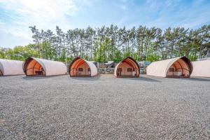 a row of white tents in a parking lot at Seocheon Ocean Place Glamping Caravan in Seocheon