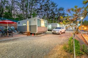 a car parked in front of two rvs at Seocheon Ocean Place Glamping Caravan in Seocheon