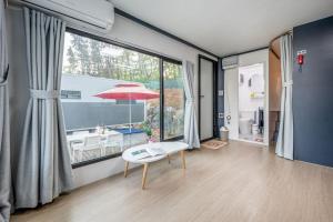 a living room with a table and a large window at Seocheon Ocean Place Glamping Caravan in Seocheon +18 photos