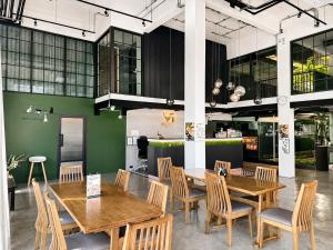 a dining room with wooden tables and chairs at V1 boutique hotel in Kanchanaburi City