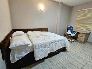 a bedroom with a bed and a desk and a chair at This apartment blends elegance and calm in Mills Center