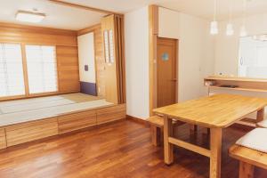 a room with a sauna and a wooden table at 民泊八のや in Hachioji