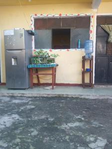 a refrigerator and a table in front of a building at House the Cats in Panajachel +13 photos