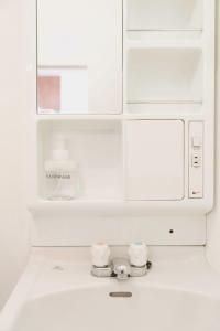a white microwave oven sitting on top of a kitchen counter at Haul Sakuramachi in Kumamoto +22 photos