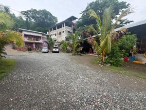 a street with cars parked in front of a building at RF Hotel Transient House in Bangued