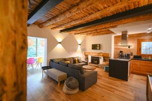 a living room with a couch and a kitchen at Xalet Les Avellanes - hut 7335 in Arinsal