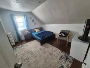 a small room with a bed and a chair at Humble beginning 605 EM in Norwich +28 photos