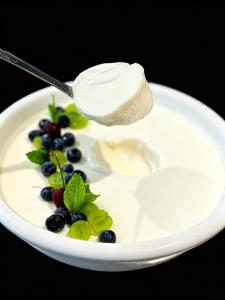 a spoonful of yogurt and berries on a plate at Paradox Kunshan in Kunshan